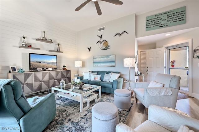 living room featuring ceiling fan and light wood-type flooring