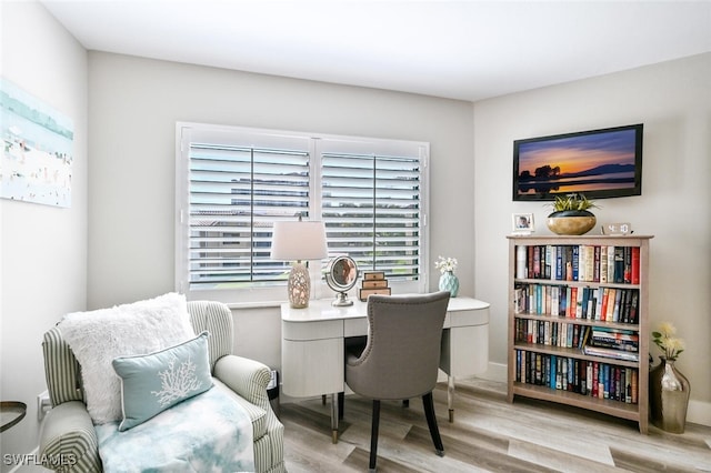 home office with light hardwood / wood-style flooring