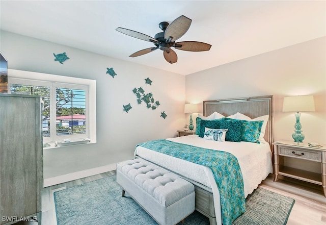 bedroom with ceiling fan and light hardwood / wood-style flooring