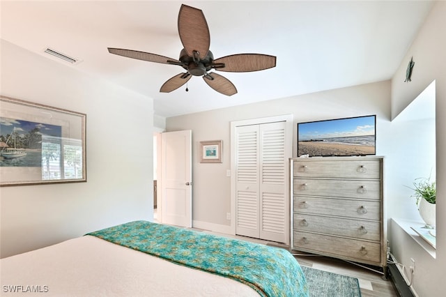 unfurnished bedroom with ceiling fan, wood-type flooring, and a closet