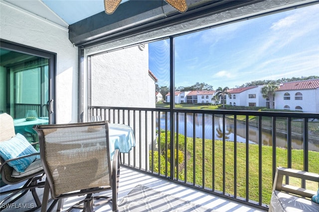 sunroom / solarium with a water view