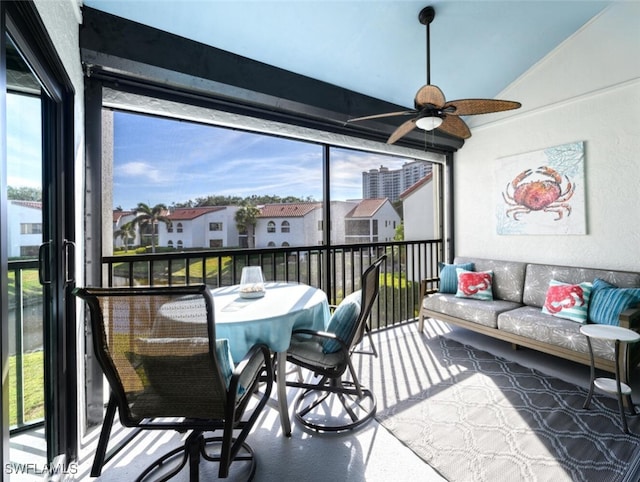 sunroom / solarium featuring ceiling fan