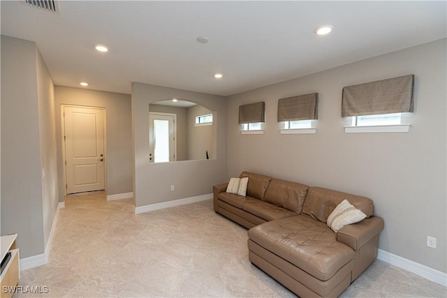 living room with baseboards, visible vents, and recessed lighting