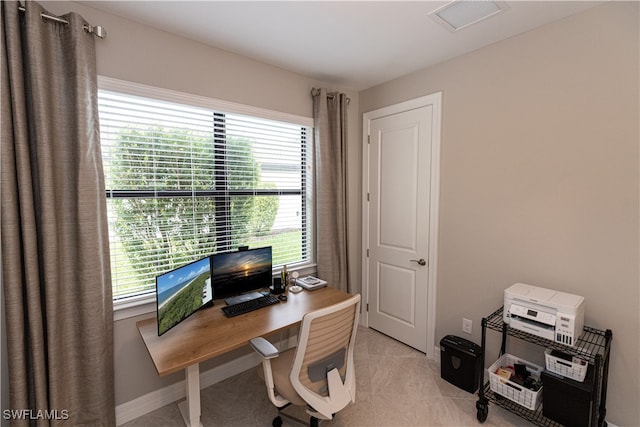 office featuring baseboards, visible vents, and light tile patterned flooring