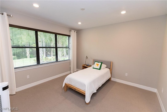 bedroom featuring light colored carpet