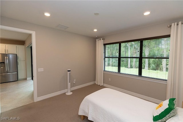 bedroom featuring recessed lighting, baseboards, light colored carpet, and stainless steel fridge with ice dispenser