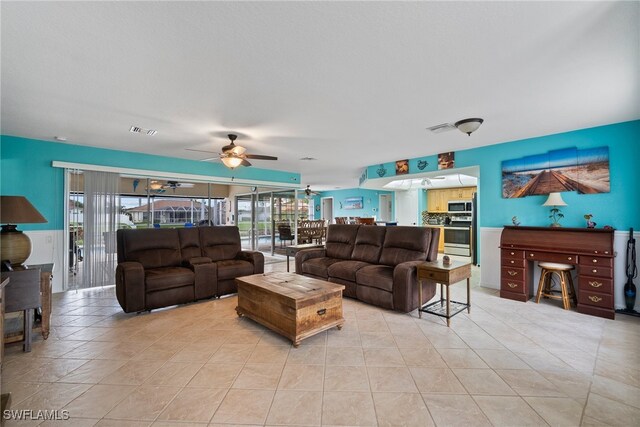 living room with ceiling fan and light tile patterned floors