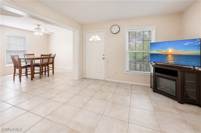 entrance foyer with ceiling fan and light tile patterned floors