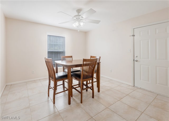 tiled dining room featuring ceiling fan