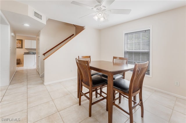 dining space featuring ceiling fan and light tile patterned floors