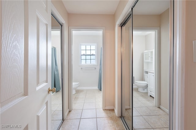 corridor with light tile patterned floors