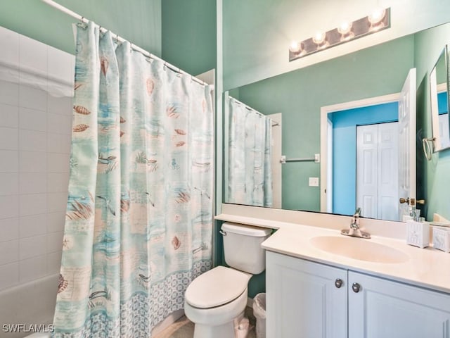 full bathroom with vanity, shower / bath combo, and toilet