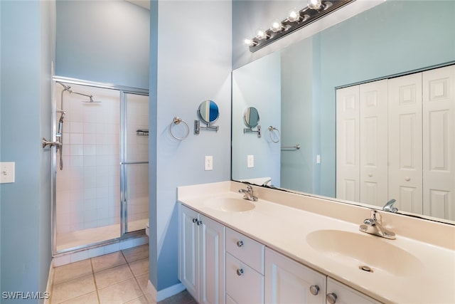 bathroom featuring tile patterned flooring, vanity, and an enclosed shower