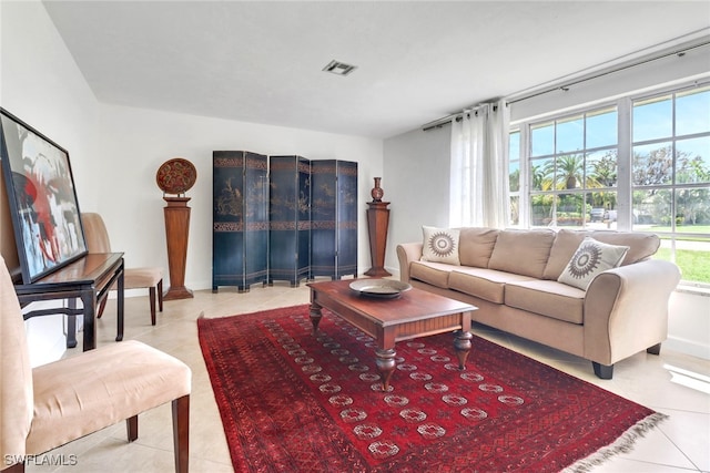 tiled living room featuring visible vents