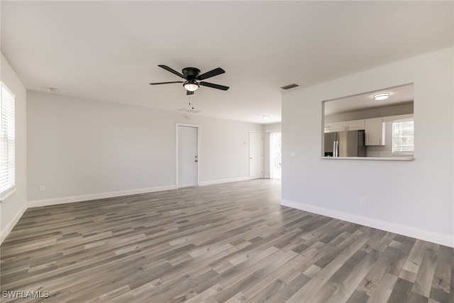 unfurnished living room featuring hardwood / wood-style floors and ceiling fan