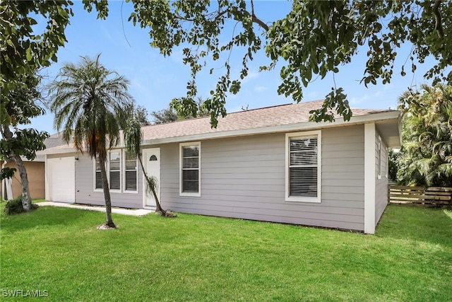 rear view of property with a lawn