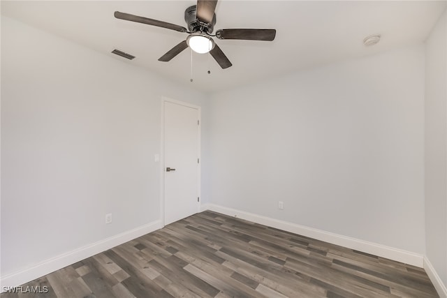 spare room featuring dark hardwood / wood-style floors and ceiling fan