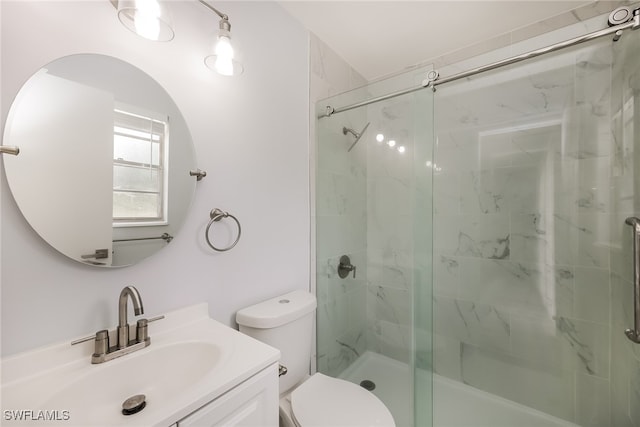 bathroom with toilet, vanity, and an enclosed shower