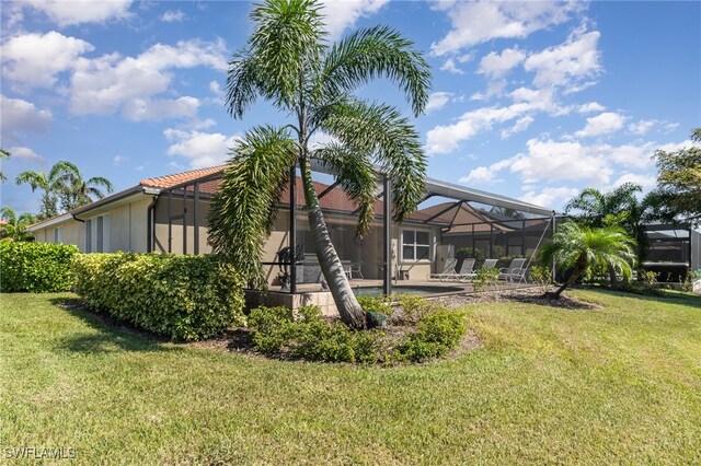 view of yard with a patio area, a lanai, and a swimming pool