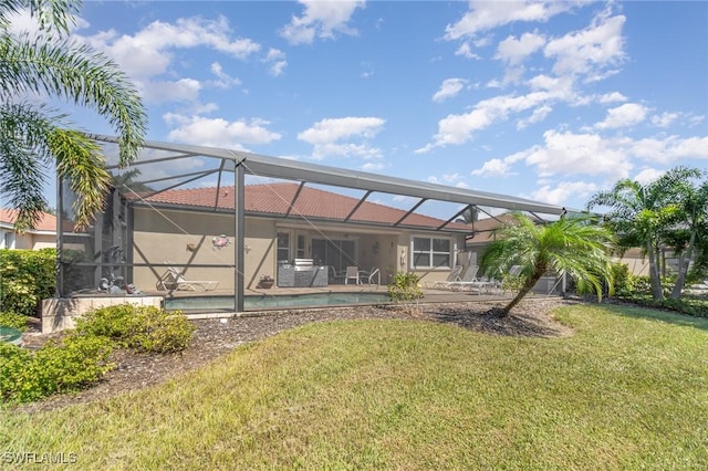 rear view of property with an outdoor pool, stucco siding, a tile roof, a patio area, and a lawn