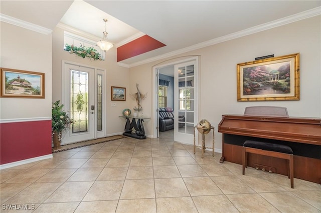 entrance foyer with light tile patterned floors, baseboards, and ornamental molding