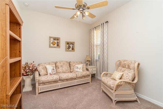 living area with carpet and ceiling fan