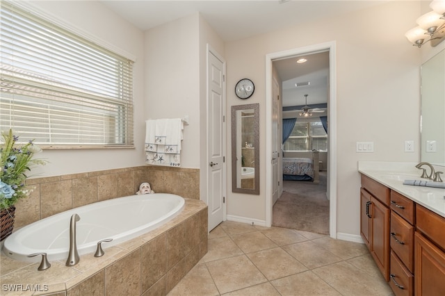 bathroom featuring vanity, ceiling fan, tiled bath, and tile patterned floors