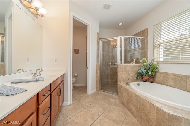 full bathroom with vanity, toilet, tile patterned floors, and plus walk in shower