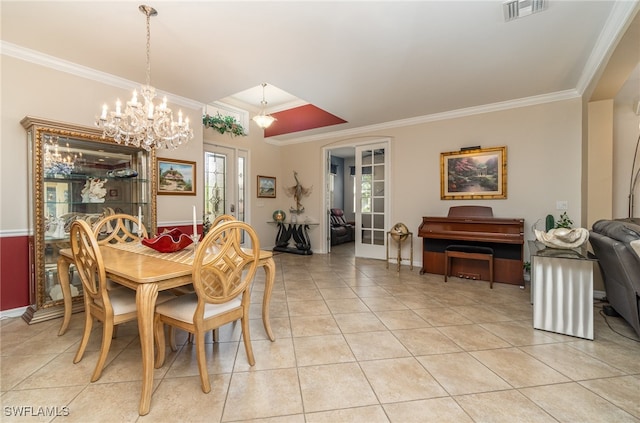 dining area with a notable chandelier, ornamental molding, and light tile patterned floors