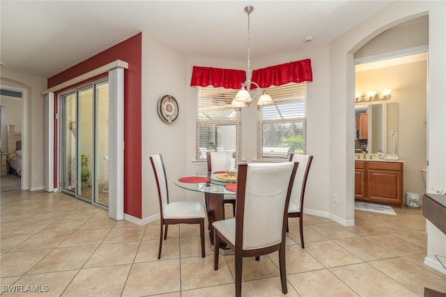 dining area with a chandelier and light tile patterned floors