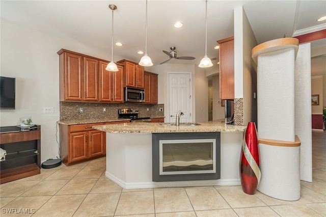 kitchen with kitchen peninsula, stainless steel appliances, sink, pendant lighting, and light stone counters