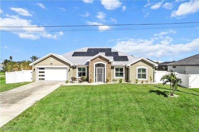 view of front of property with a front yard, solar panels, and a garage