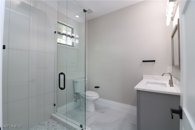 bathroom with vanity, tile patterned flooring, toilet, and an enclosed shower