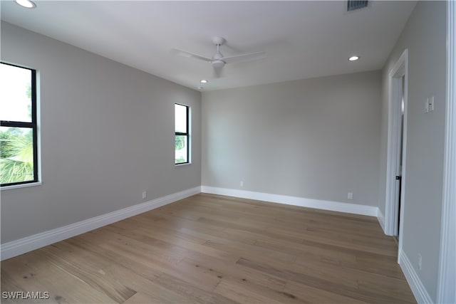 unfurnished room with light wood-type flooring and ceiling fan