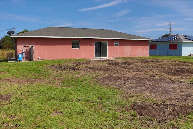 rear view of property with a yard