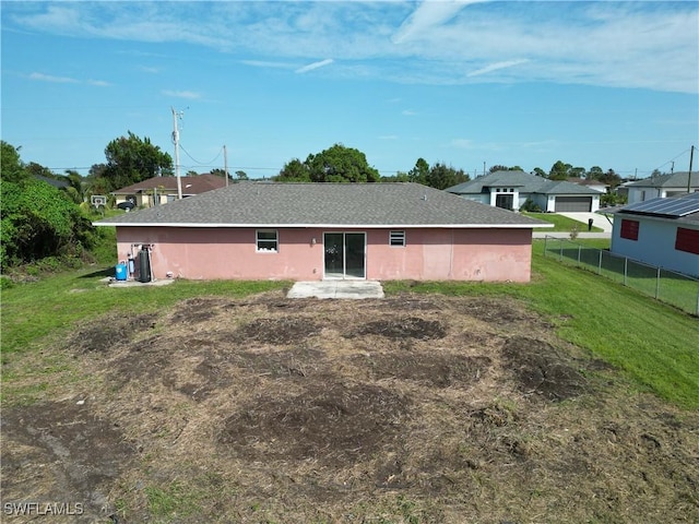 rear view of property with a yard