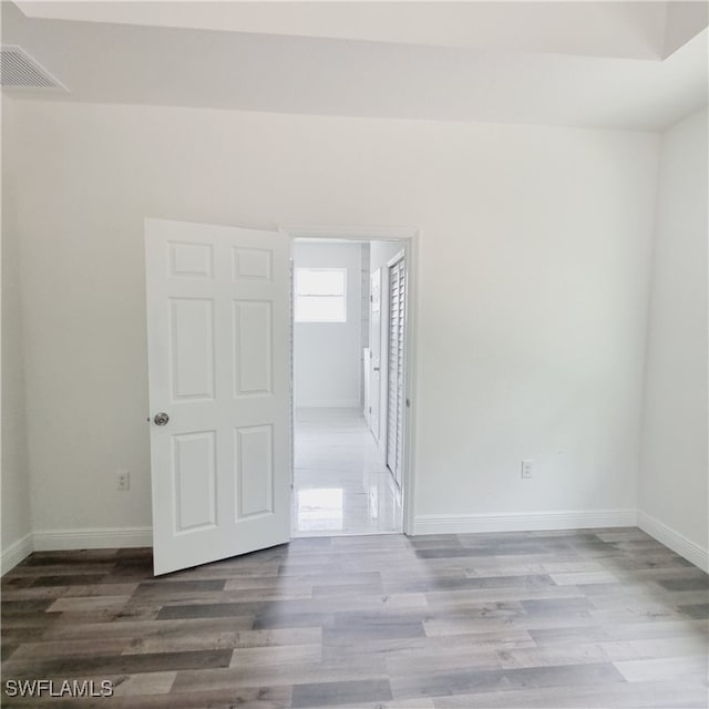 spare room with wood-type flooring