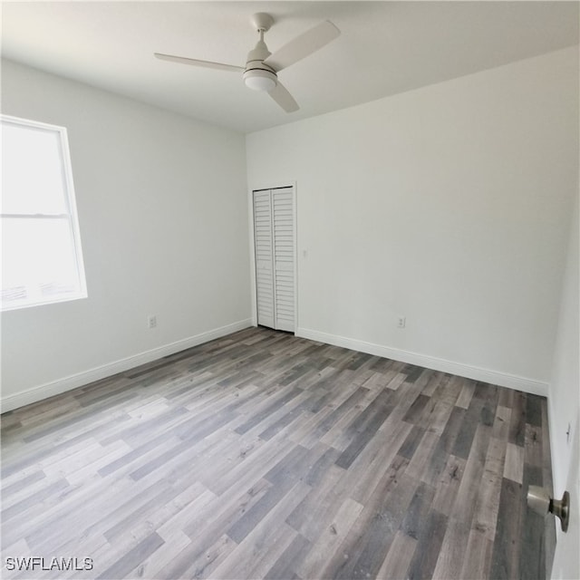 spare room featuring light hardwood / wood-style flooring and ceiling fan