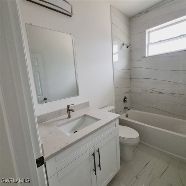 full bathroom with vanity, tiled shower / bath, and toilet