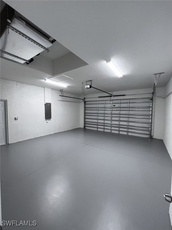 garage with a garage door opener and electric panel