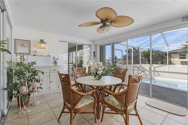 sunroom featuring ceiling fan and a wealth of natural light