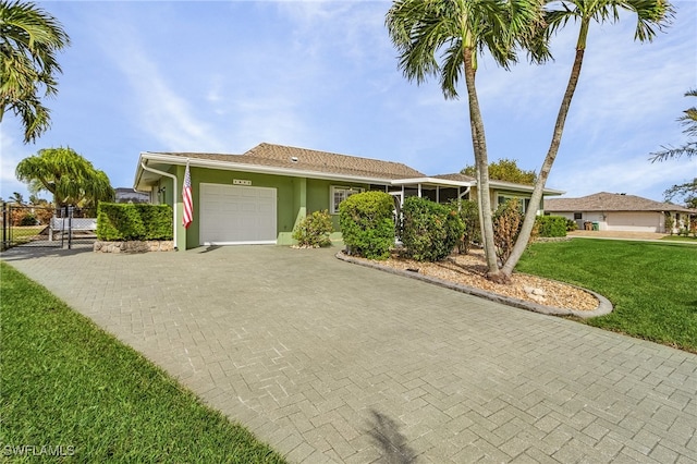 view of front of home with a front lawn and a garage