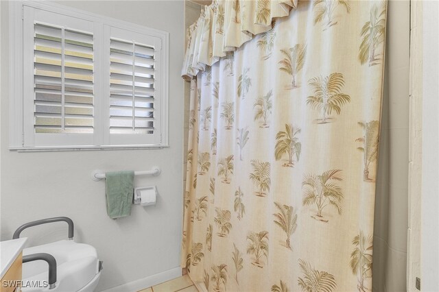 bathroom with walk in shower, vanity, toilet, and tile patterned flooring