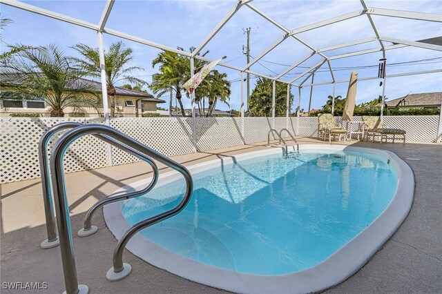 view of pool featuring a patio area and glass enclosure