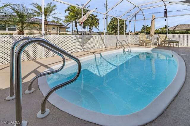 view of pool featuring a patio and a lanai