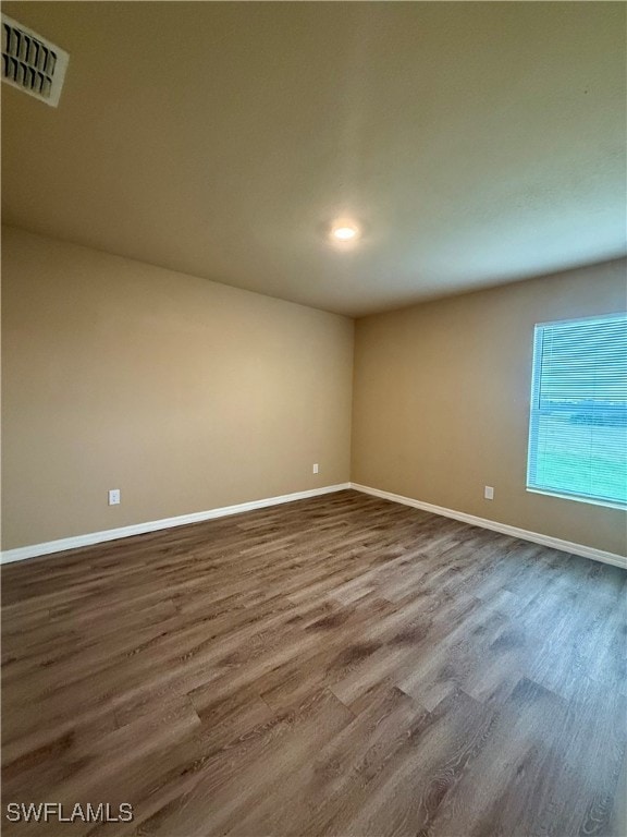 empty room featuring dark wood-type flooring