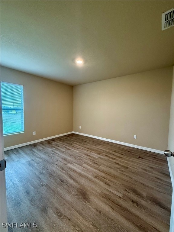 unfurnished room featuring hardwood / wood-style flooring