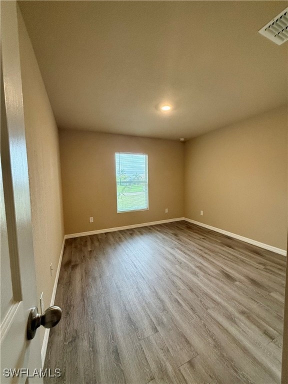 unfurnished room featuring hardwood / wood-style floors