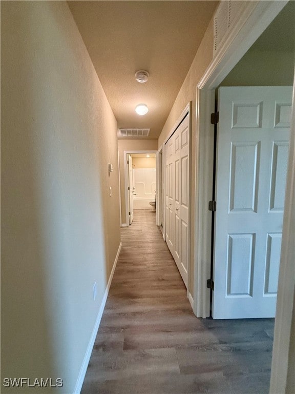 hallway with light hardwood / wood-style flooring