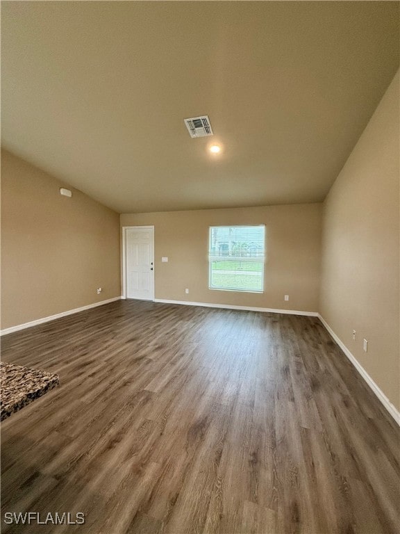 unfurnished room with dark wood-type flooring